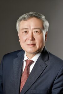 A confident mature businessman posing in a suit, exuding leadership and professionalism.